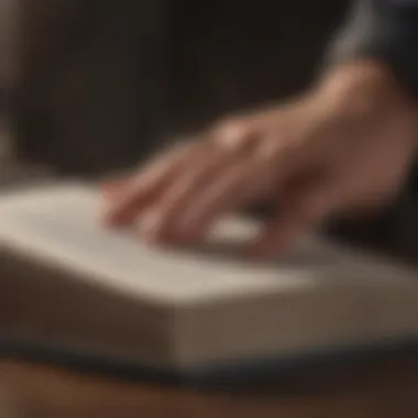 Engaging with Knowledge A close-up of a hand turning the pages of an open book